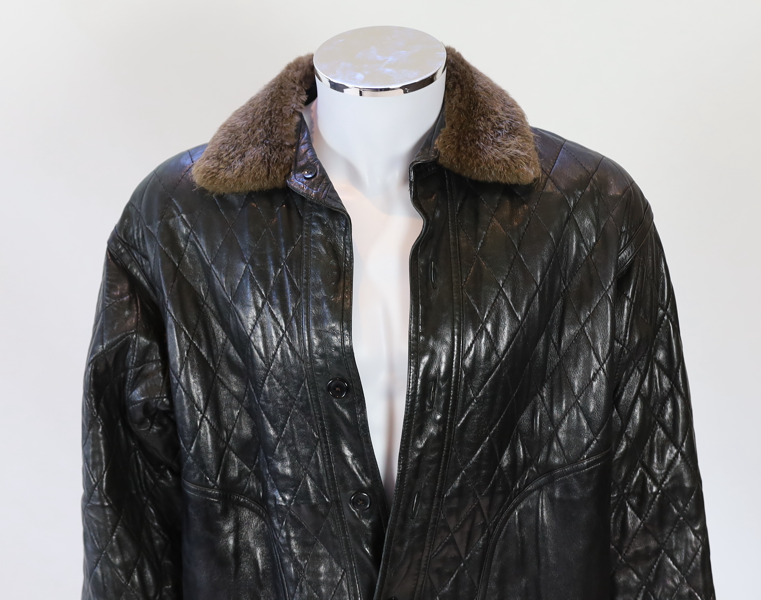 A Yves Saint Laurent Fourrures gentlemen's black quilted leather bomber jacket with fur collar and lining, approx size 42